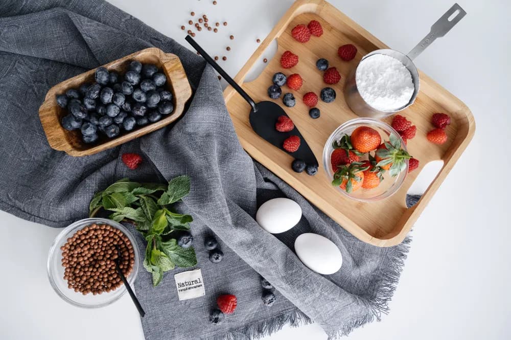 Fresh berries and botanical ingredients arranged as a flatlay