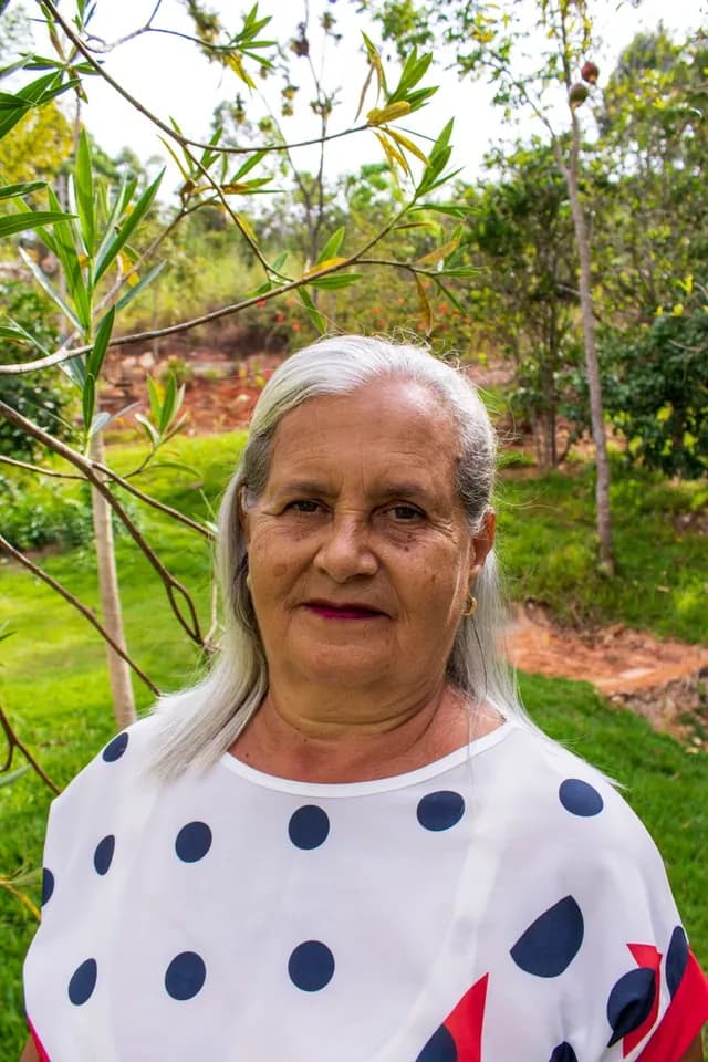 An elderly member smiling in a garden