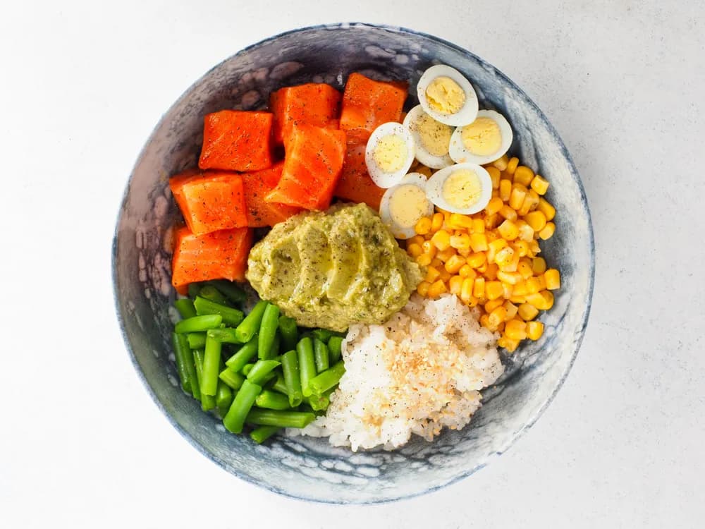A balanced meal bowl with fish, grains and greens
